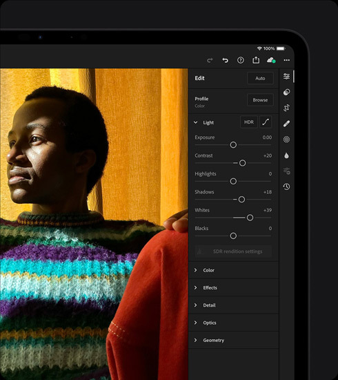 iPad Pro, displaying a photograph of a person in a colorful sweater being edited