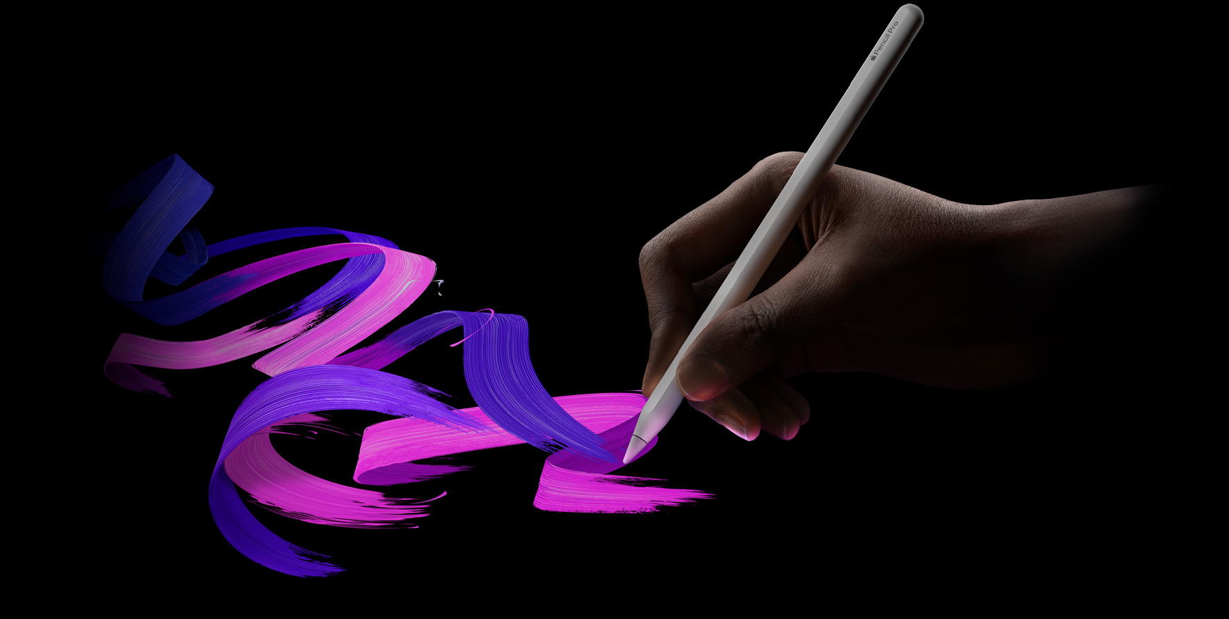 ユーザーがApple Pencil Proを持ち、色あざやかなブラシの線を描いている。