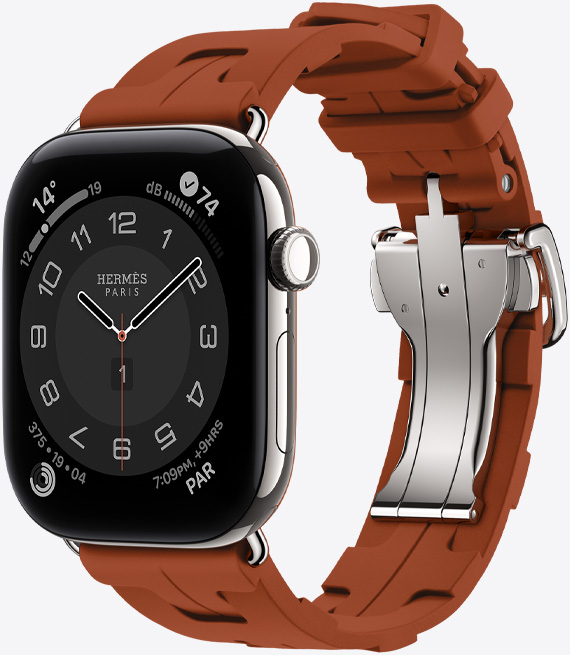 Apple Watch Hermès Series 12, Circulaire analog watch face, (hour, minute and second hands, complications: Weather, Noise, Activity rings, and Paris time), titanium case, silver colour, right side exterior, Digital Crown, side button, paired with Kilim Single Tour band, cuivre colour (brown), moulded rubber material, geometric interlocking design, silver-coloured metal clasp