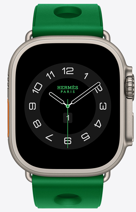 Apple Watch Hermès Ultra 4, Circulaire analog watch face, (hour, minute and second hands, complications: Weather, Activity rings, Paris time and UV index), titanium case, natural color, right side exterior, Digital Crown, raised side button, paired with Scub'H Diving band, Vert Vertigo color (bright green), molded rubber material, circular cutouts centered