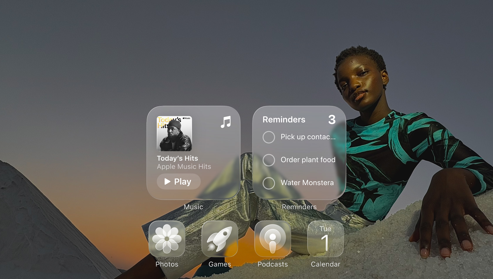 شاشة بتصميم Liquid Glass مع أيقونات شفافة لتطبيقات عدة مثل Apple Music والتذكيرات والصور والألعاب والبودكاست، وتبدو كلها منعكسة على خلفية الشاشة