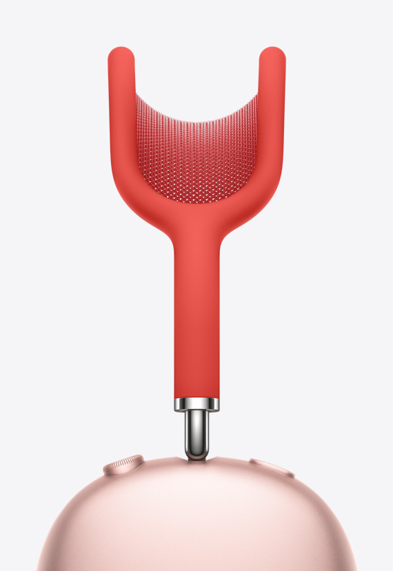 Obloga od guste mrežaste tkanine, zategnuta između zaobljene obloge u obliku slova Y, nastavlja se na dršku koja je povezana sa slušalicama AirPods Max u ružičastoj boji.