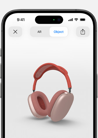 Slika na kojoj se prikazuju ružičaste AirPods Max slušalice na zaslonu Proširena stvarnost na iPhone uređaju.