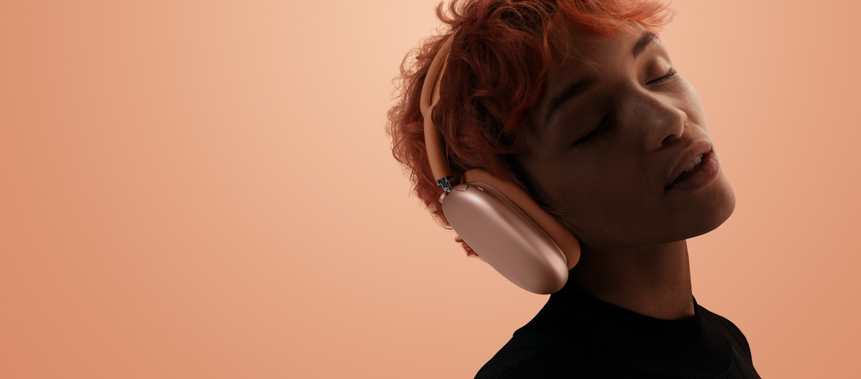 A woman with her eyes closed and head tilted to the right, wearing AirPods Max.