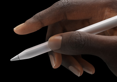 A user holds Apple Pencil Pro in a between thumb and forefinger.