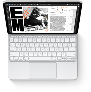 Pohled shora na iPad Pro s připnutým bílým Magic Keyboardem k iPadu Pro.