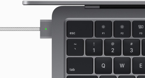 Billede ovenfra af et MagSafe-kabel, som er tilsluttet en MacBook Air i farven space grey