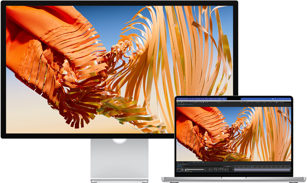 MacBook Pro 擺放在 Studio Display 旁邊。