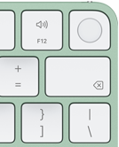 Magic Keyboard, top-right corner, green color, Touch ID , delete key, and volume function keys