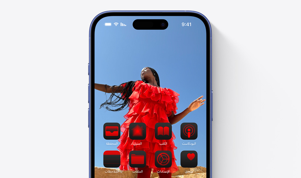 iPhone 16  screen with a photo of a girl in a red dress and widgets tinted a similar color red.