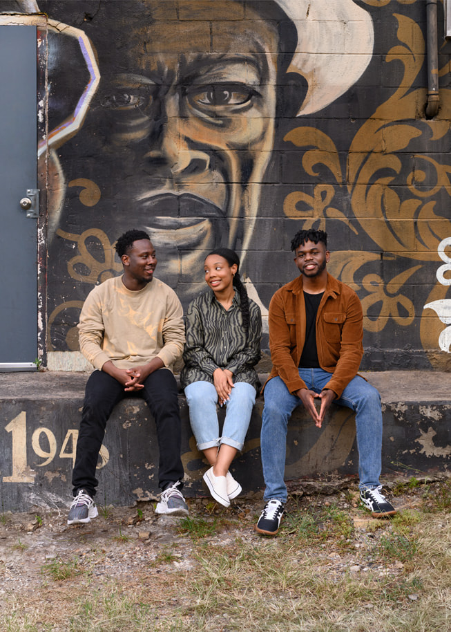 Apple Entrepreneur Camp participants Harold Lomotey, Ashley McKoy and Ositanachi Otugo are shown in front of a mural in Austin, Texas, USA.