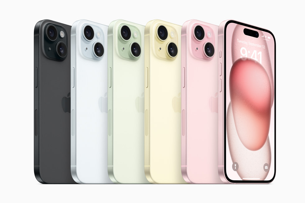 A row of iPhone 15 devices show the lineup’s new colors: black, blue, green, yellow, and pink.