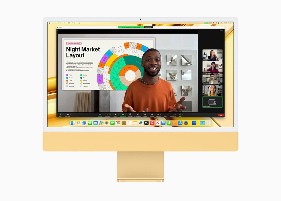 搭載 M3 的黃色全新 iMac 上展示視訊會議。