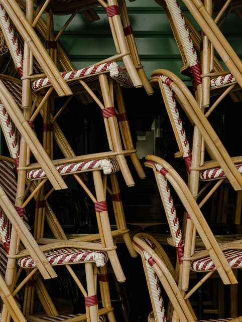 Een close-up van op elkaar gestapelde caféstoelen, gemaakt met iPhone 15 Pro Max.