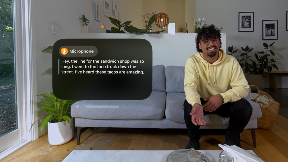 The Live Captions experience in visionOS is shown from an Apple Vision Pro user's point of view.