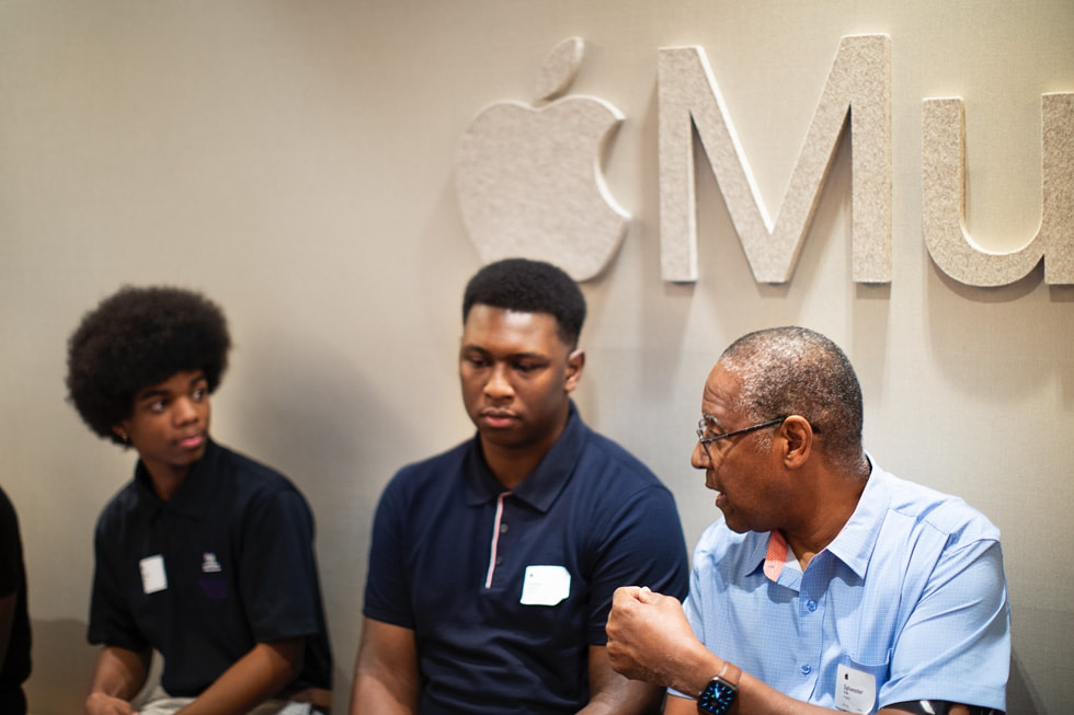 From left: Students Khalid Gray and Torrien Howard speak with professor Sylvester Polk at Apple Music Nashville.