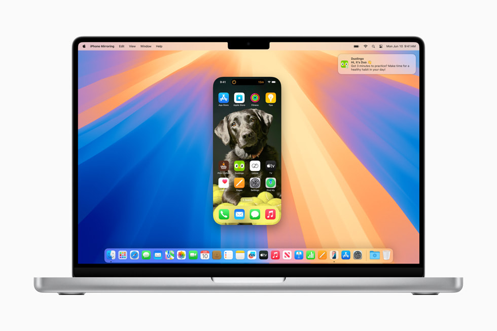 With iPhone Mirroring, a user wirelessly uses their iPhone 15 Pro from the desktop of their MacBook Pro.