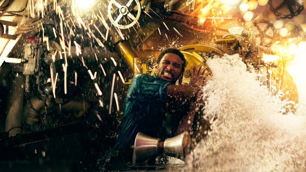 A still from “Submerged” shows a sailor struggling with a rush of water and sparks flying.