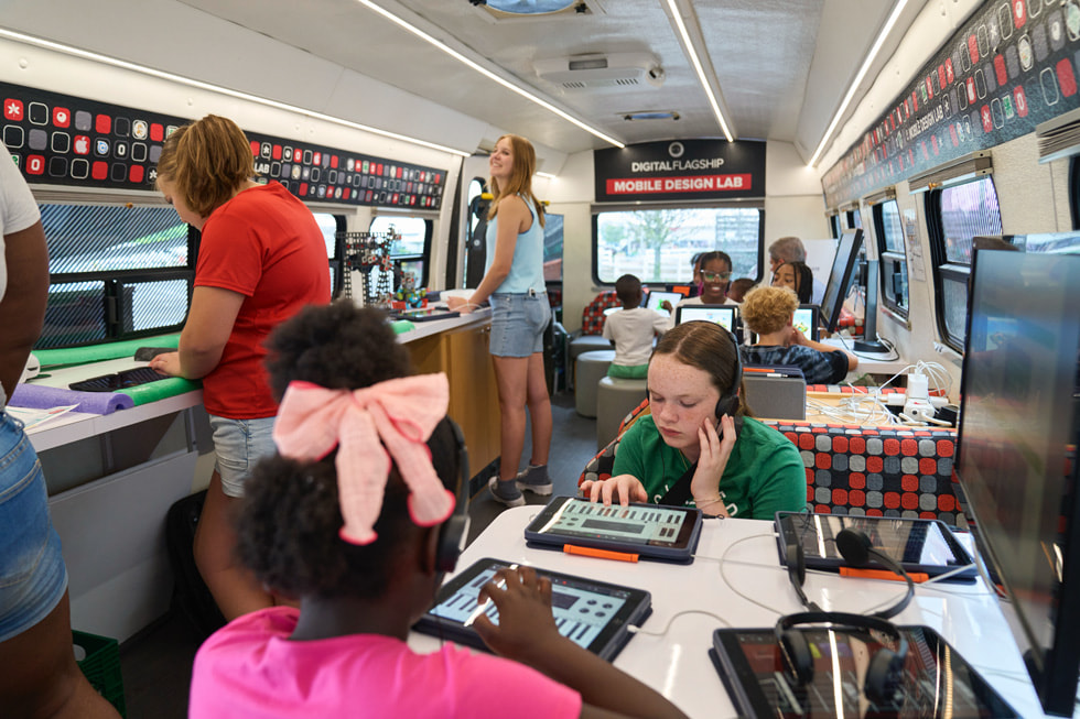 4-H club members using Apple Pencil in GarageBand on iPad inside the mobile classroom bus.