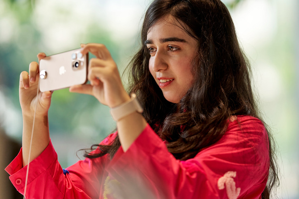 A customer holds up iPhone 16 Pro at Apple BKC in Mumbai.