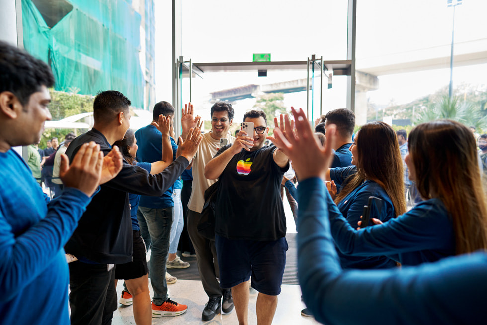 Team members welcome customers as they enter Apple BKC in Mumbai.