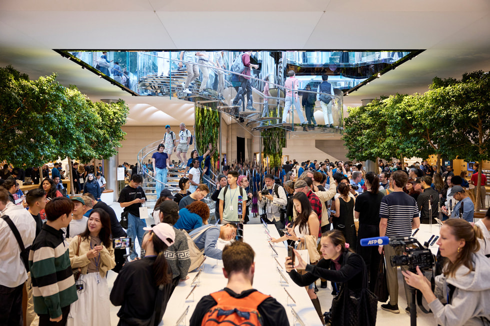 A bustling scene full of customers and team members at Apple Fifth Avenue in New York City.