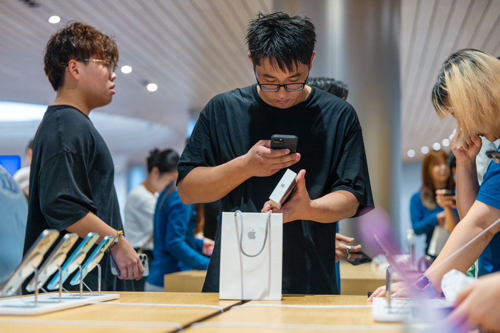 A customer checks out his new iPhone purchase.