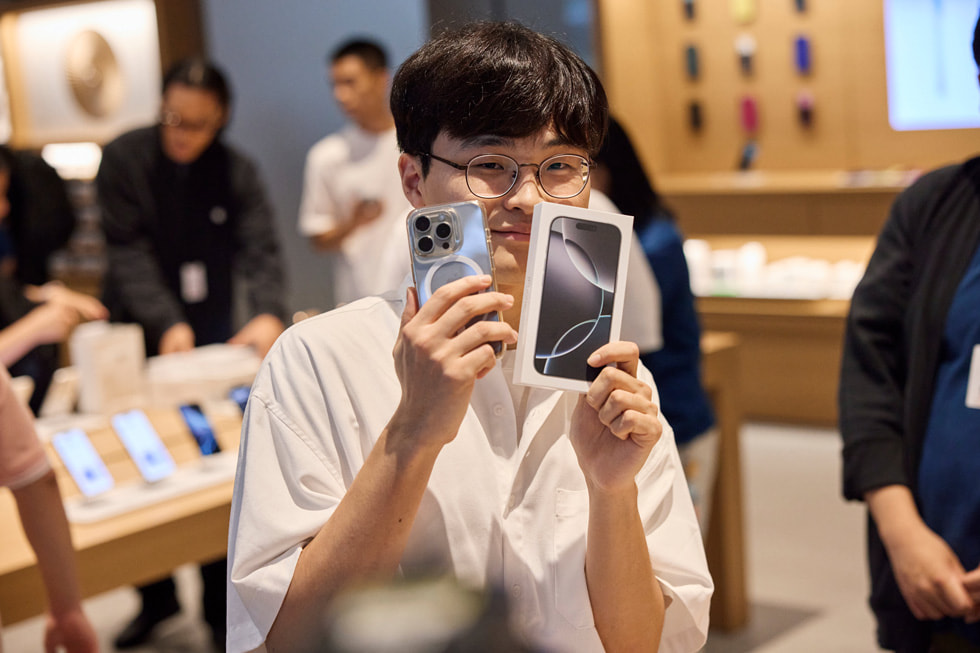 A customer shows off his old and new iPhones.