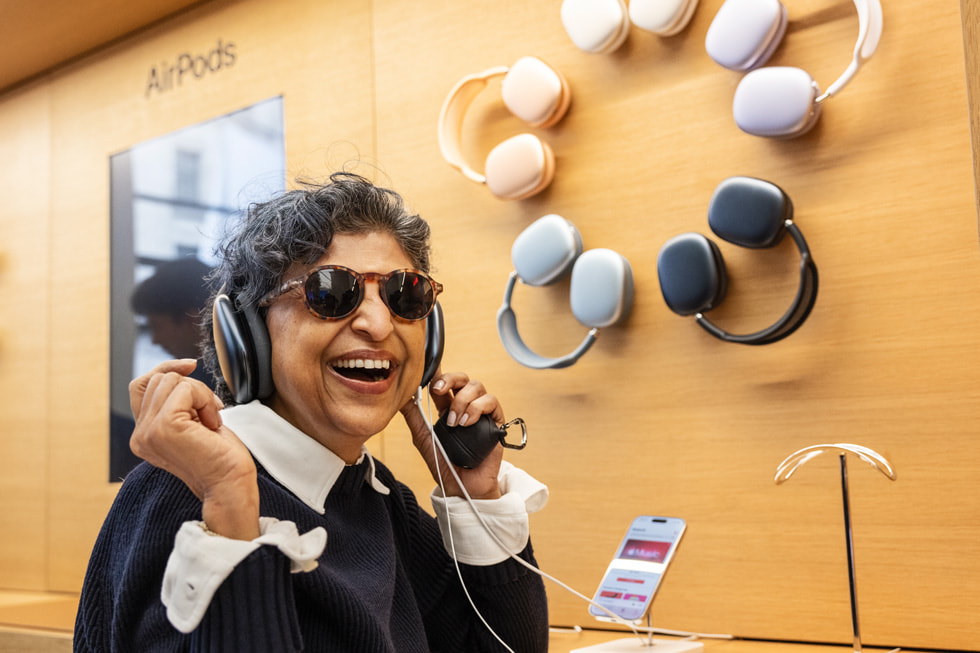 A customer tries on AirPods Max in midnight at Apple Regent Street in London.