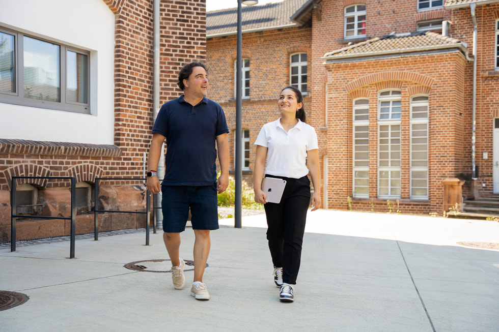 CodeDoor's Karan Dehghani walks outdoors with participant Dunya Khalo.