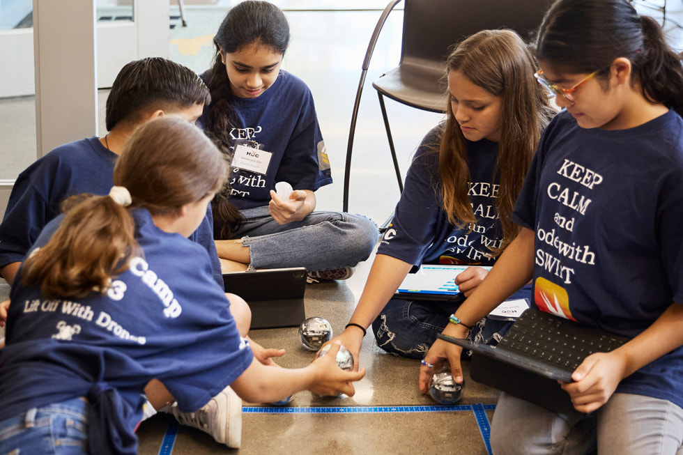 Sisters Soleil (far left) and Lluvia San Miguel (second from right) work with their fellow campers to guide Sphero robots through an obstacle course at Houston Community College’s technology summer camp. 