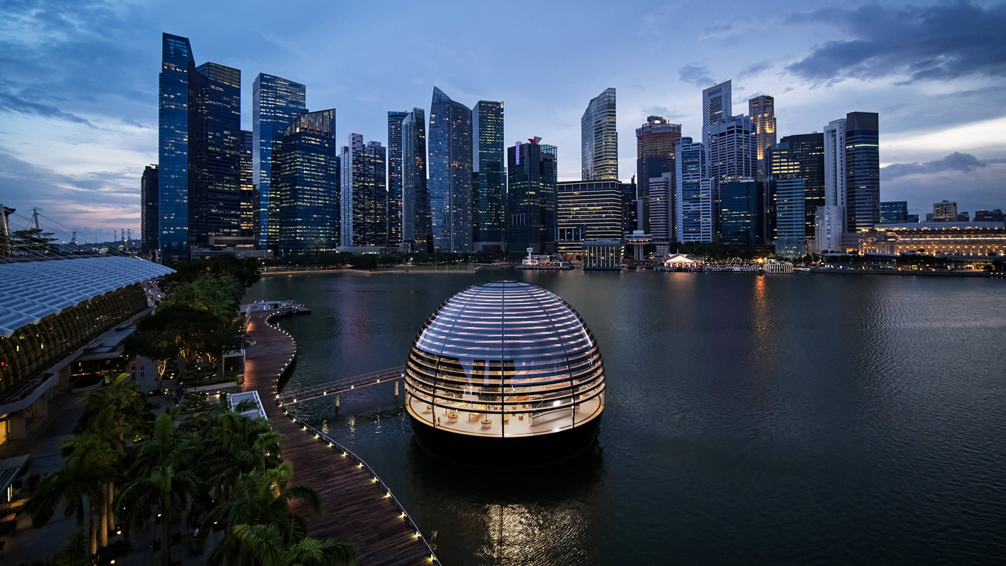Exterior of Apple Marina Bay Sands dome with the city skyline.