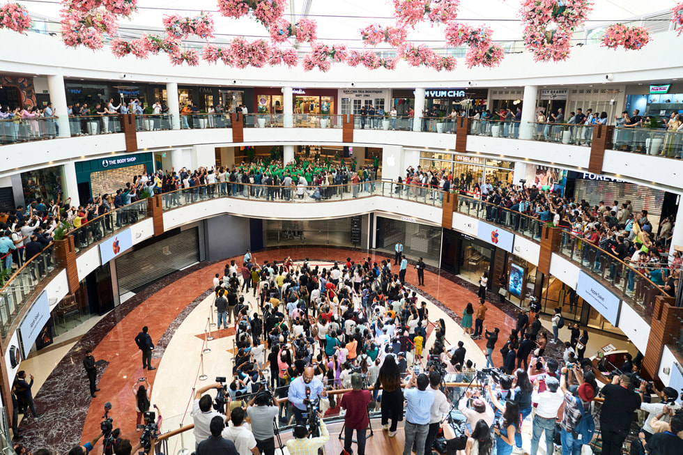 Several bustling levels of the mall outside of Apple Saket's store entrance are shown.