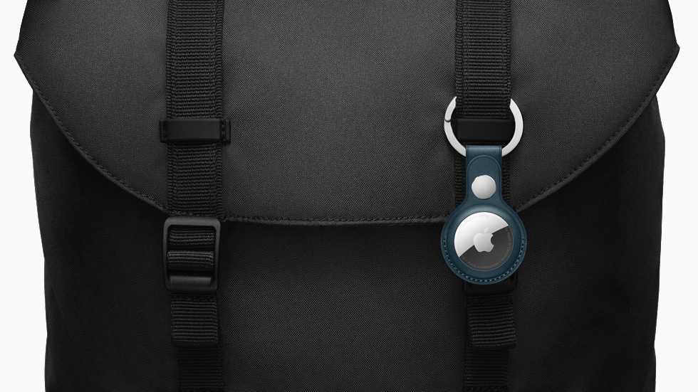 AirTag accessorized with the Leather Key Ring, attached to a messenger bag.