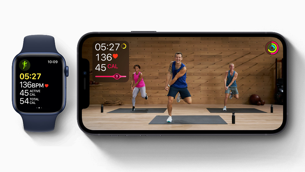 Apple Fitness+ Studio workout displayed on iPhone 12, and workout in progress on Apple Watch Series 6.
