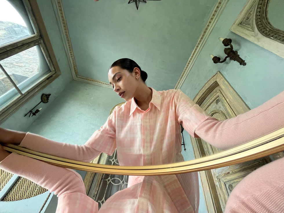 Mirrored perspective photograph of a woman taken on iPhone 13’s Ultra Wide camera.