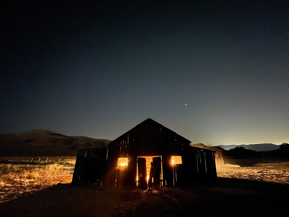 An outdoor Night mode photo of a barn shot on iPhone 12.