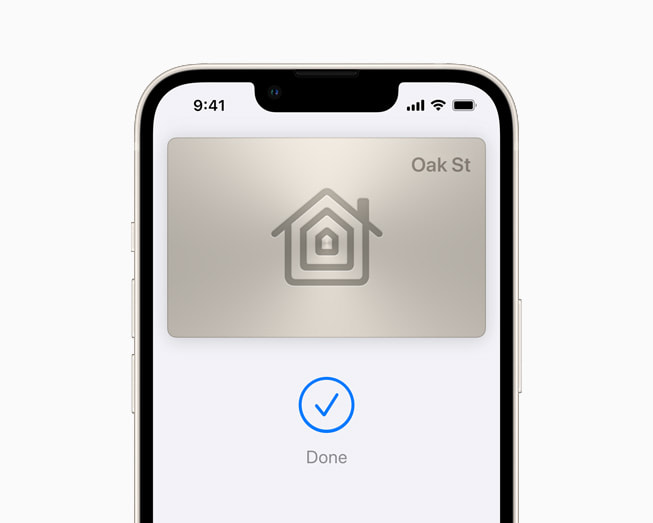 iOS 15 using a house key in Wallet on a starlight iPhone 13.