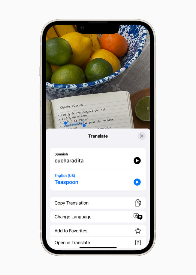iOS 15 using Translate to translate Spanish text to English on a starlight iPhone 13.