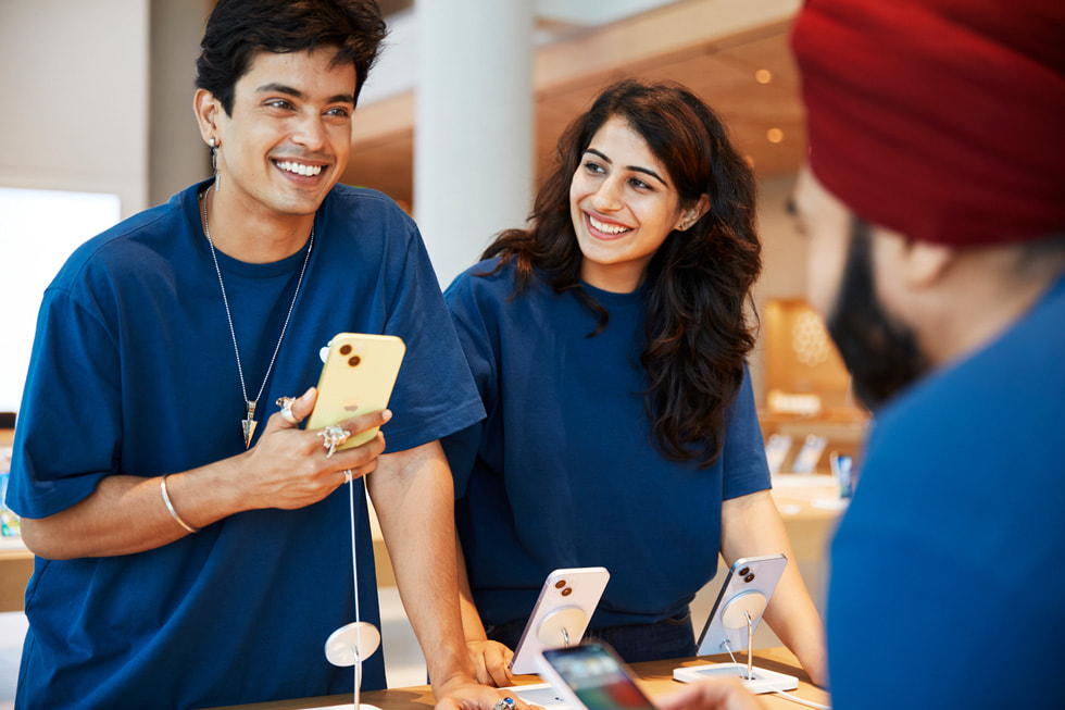 Apple BKC team members stand at the dedicated Apple Pick-up area inside the store.