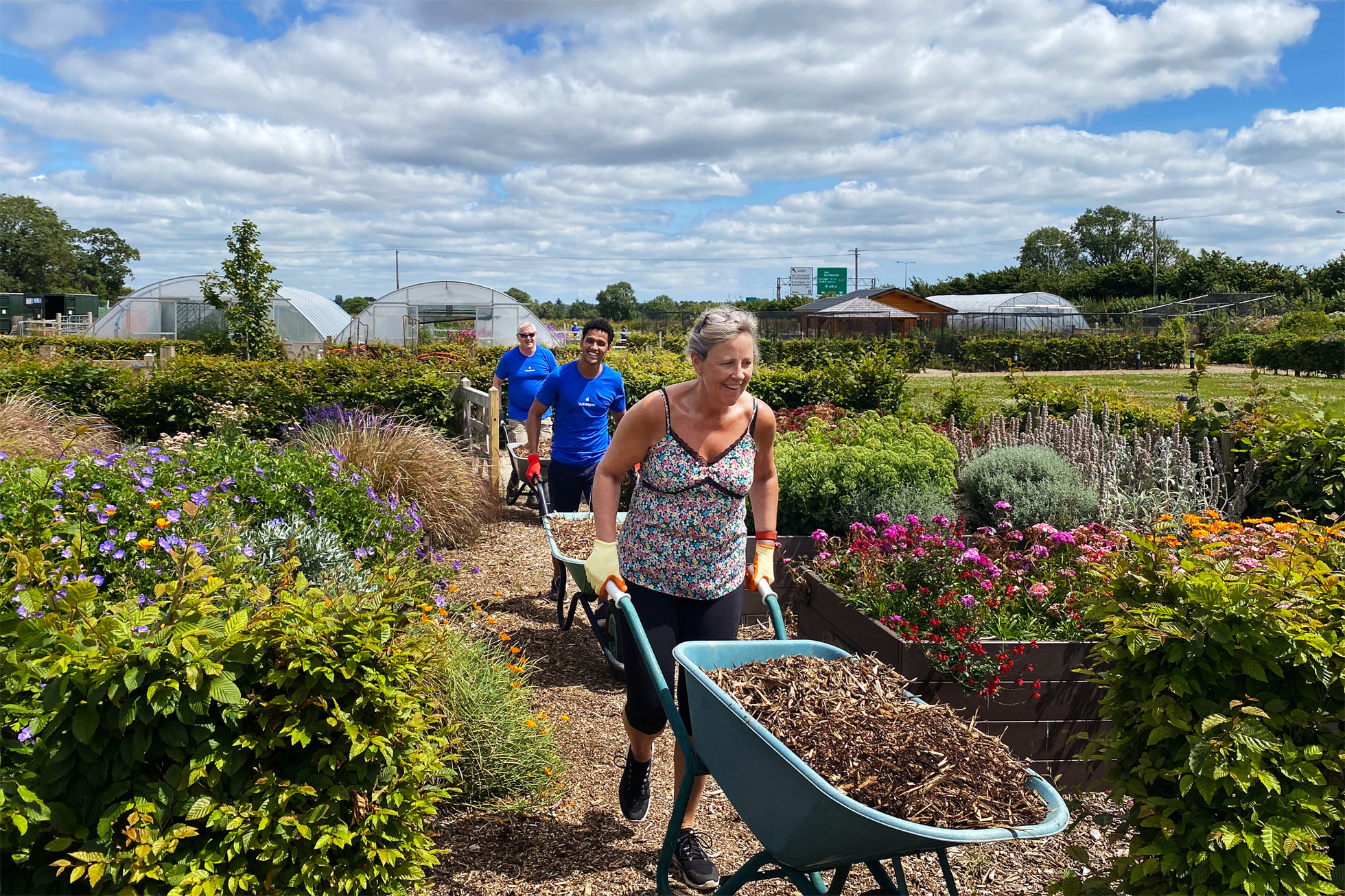 An Apple volunteer pushes a wheelbarrow at Field of Dreams in Cork, Ireland.