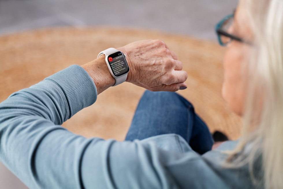 An elderly woman receiving a high heart rate notification on Apple Watch Series 8.