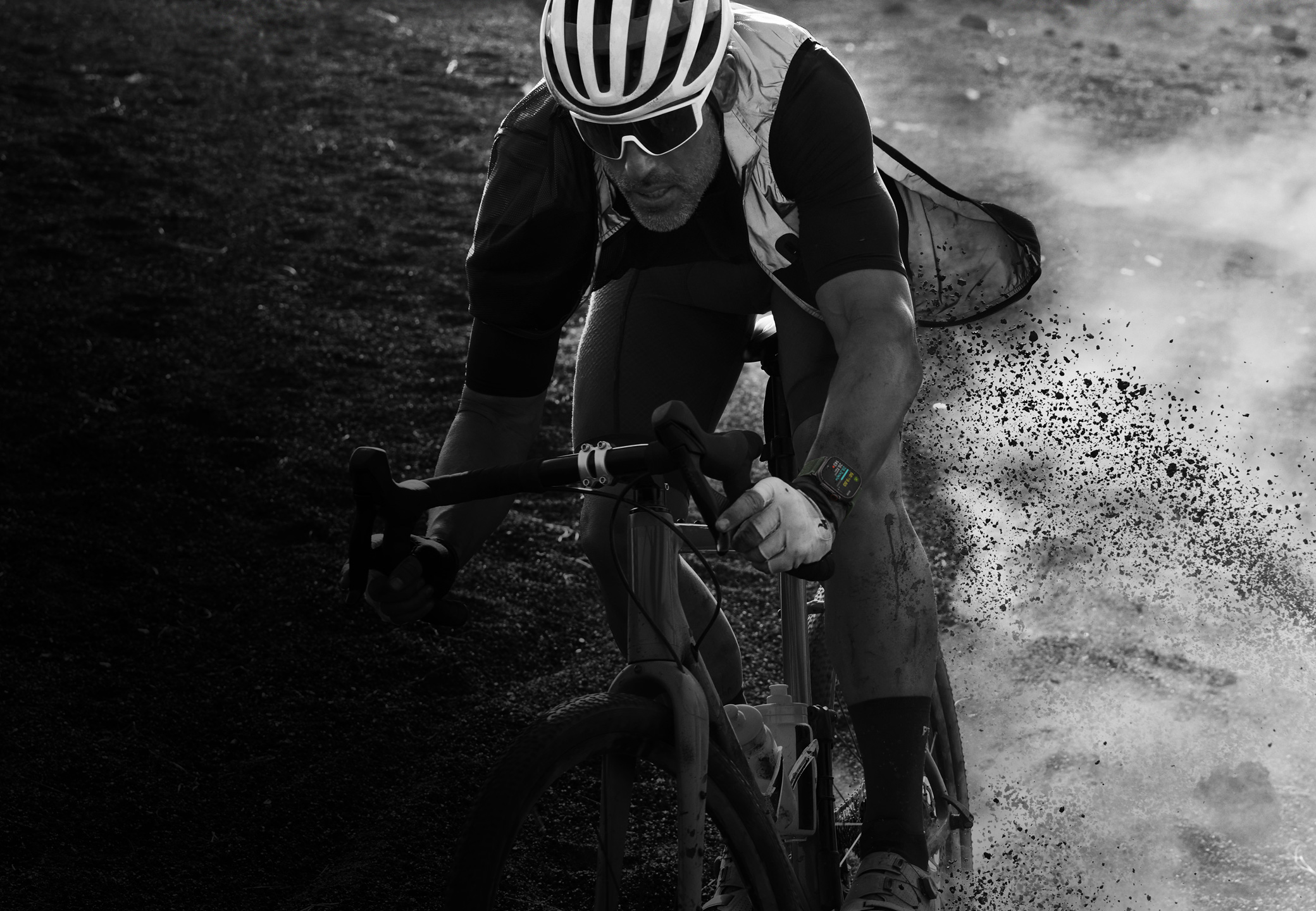 A person riding a bicycle down a rocky trail wearing Apple Watch Ultra 2.