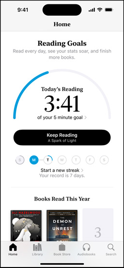 iPhone screen showing the Reading Goals interface in the Books app. At the top, there is a progress ring. Below the progress ring is the weekly reading streak tracker. At the bottom is the Books Read This Year section, which includes a row of two books, with an empty slot for a third