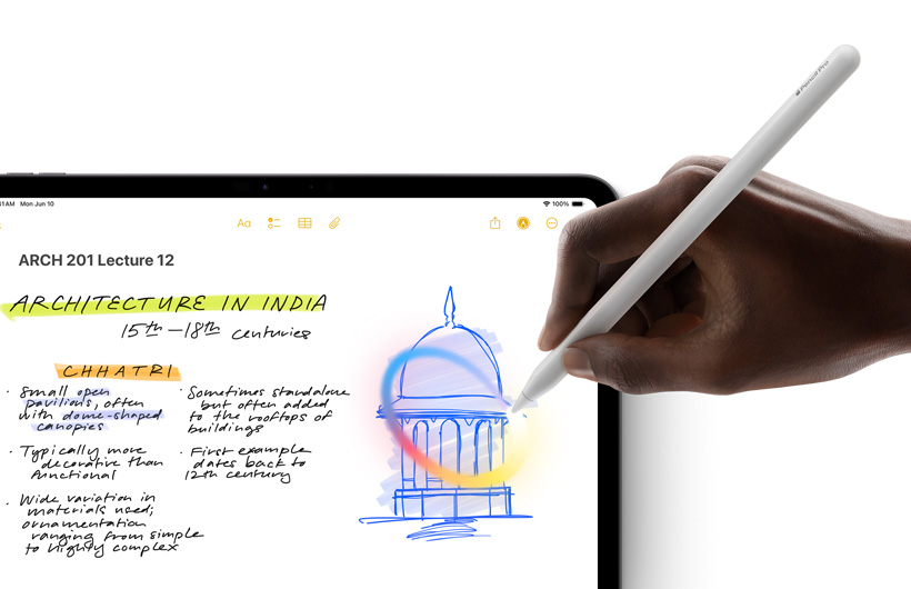 A hand holding Apple Pencil draws a circle around a sketch in the Notes app on iPad.