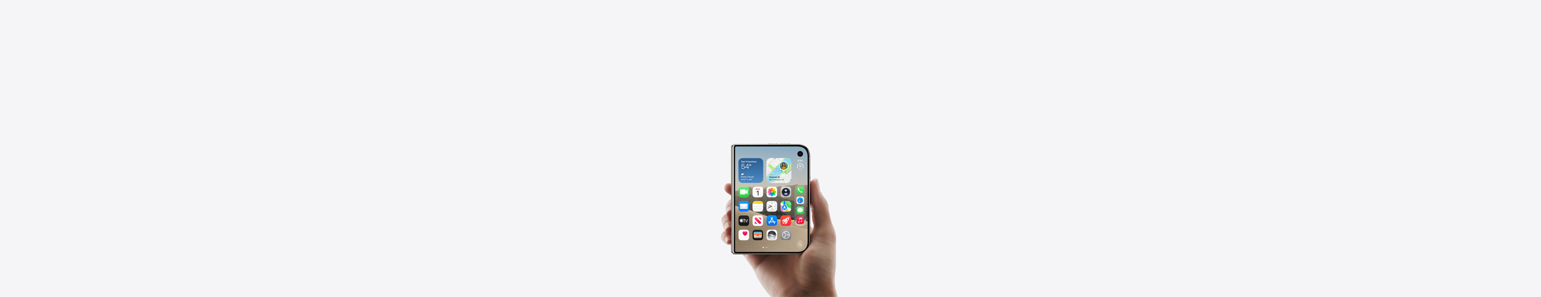 iPhone Duo, Star White color, held by a hand in closed position, outer display shown, iOS home screen with apps and widgets.