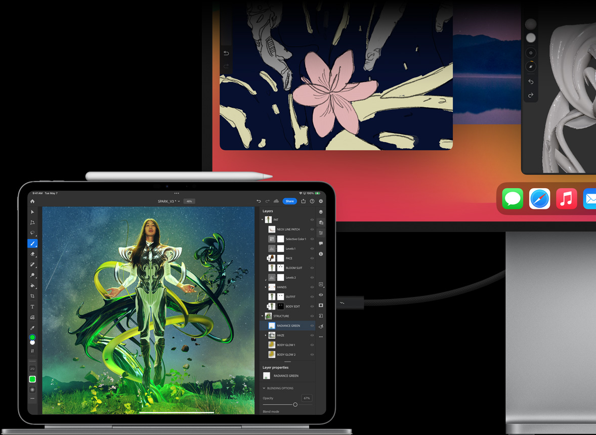 iPad Pro fastgjort til Magic Keyboard i vandret position, en ekstern skærm er tilsluttet, billeder bliver redigeret på begge enheder