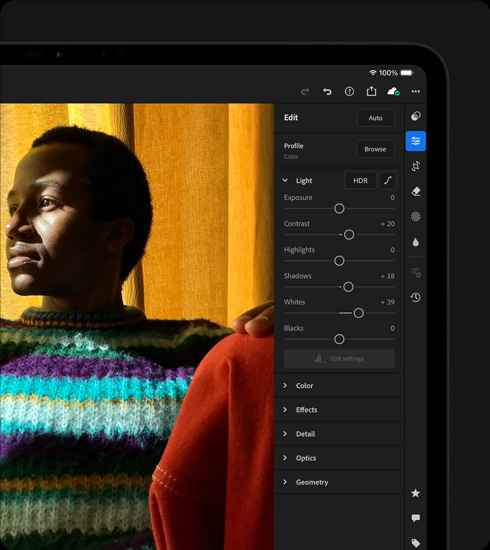 iPad Pro, front exterior, landscape orientation, space black color, display showing a photograph being edited of a person in a colorful sweater, tools and effects menu open at right