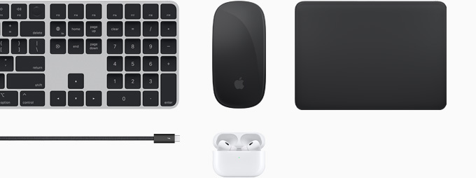 Top view of Magic Keyboard, Magic Mouse, Magic Trackpad, a Thunderbolt 4 Pro Cable and AirPods Pro together