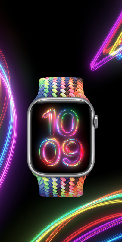 Un Apple Watch Series 9 con il nuovo cinturino Solo Loop intrecciato Pride Edition e il nuovo quadrante coordinato Raggi del Pride, dai colori fluorescenti.